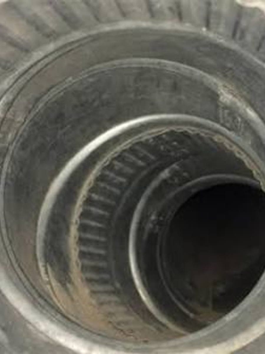 A dryer vent duct packed with compacted lint before cleaning and clear metal ducting afterwards